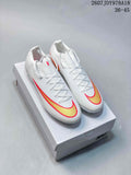 Pair of white Nike Mercurial soccer cleats with gold and red Swoosh detailing displayed on a shoebox; image text shows 2607JDY978A18 and 36–45.