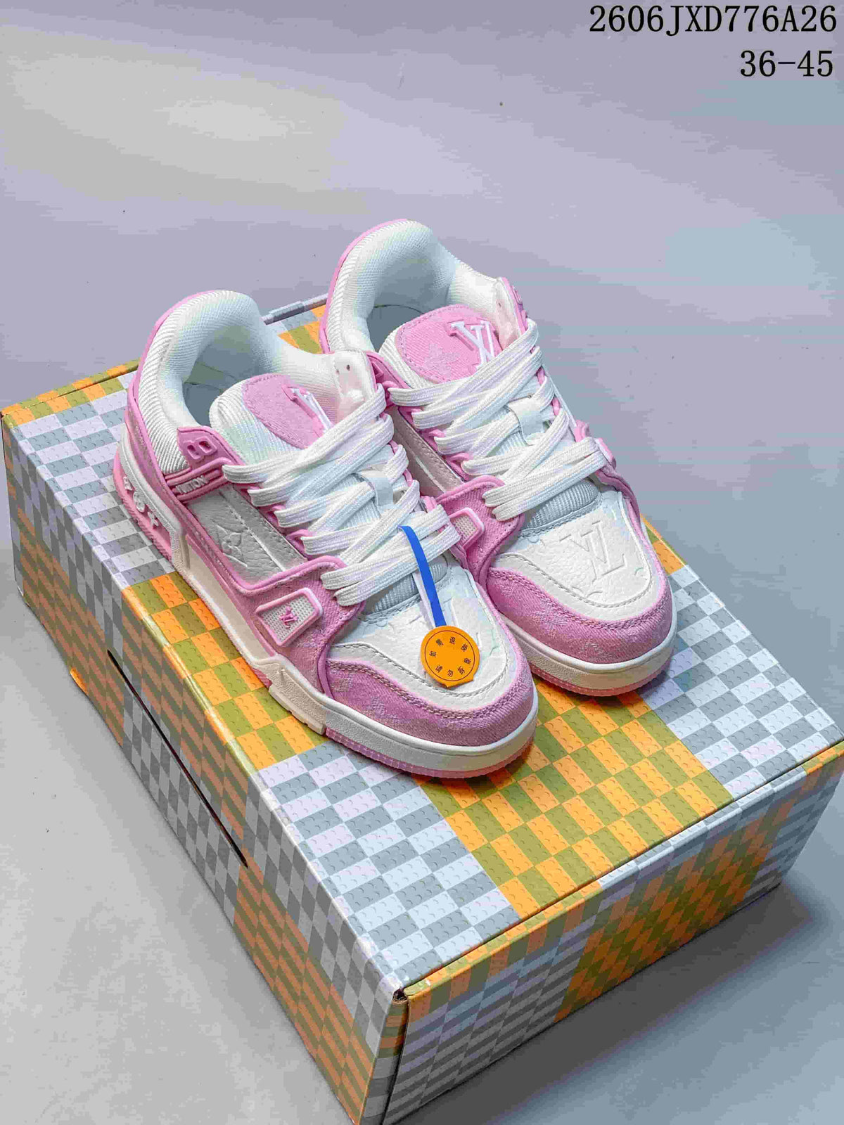 Pair of pink and white Louis Vuitton Trainer-style low-top sneakers displayed on a patterned box