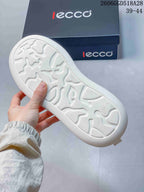 Close-up of the white sneaker outsole showing its patterned tread.