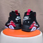 Rear view of black high-top sneakers with red pull tabs and white heel branding
