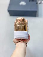 Rear view showing the metallic gold heel, visible AIR branding and layered white sole.