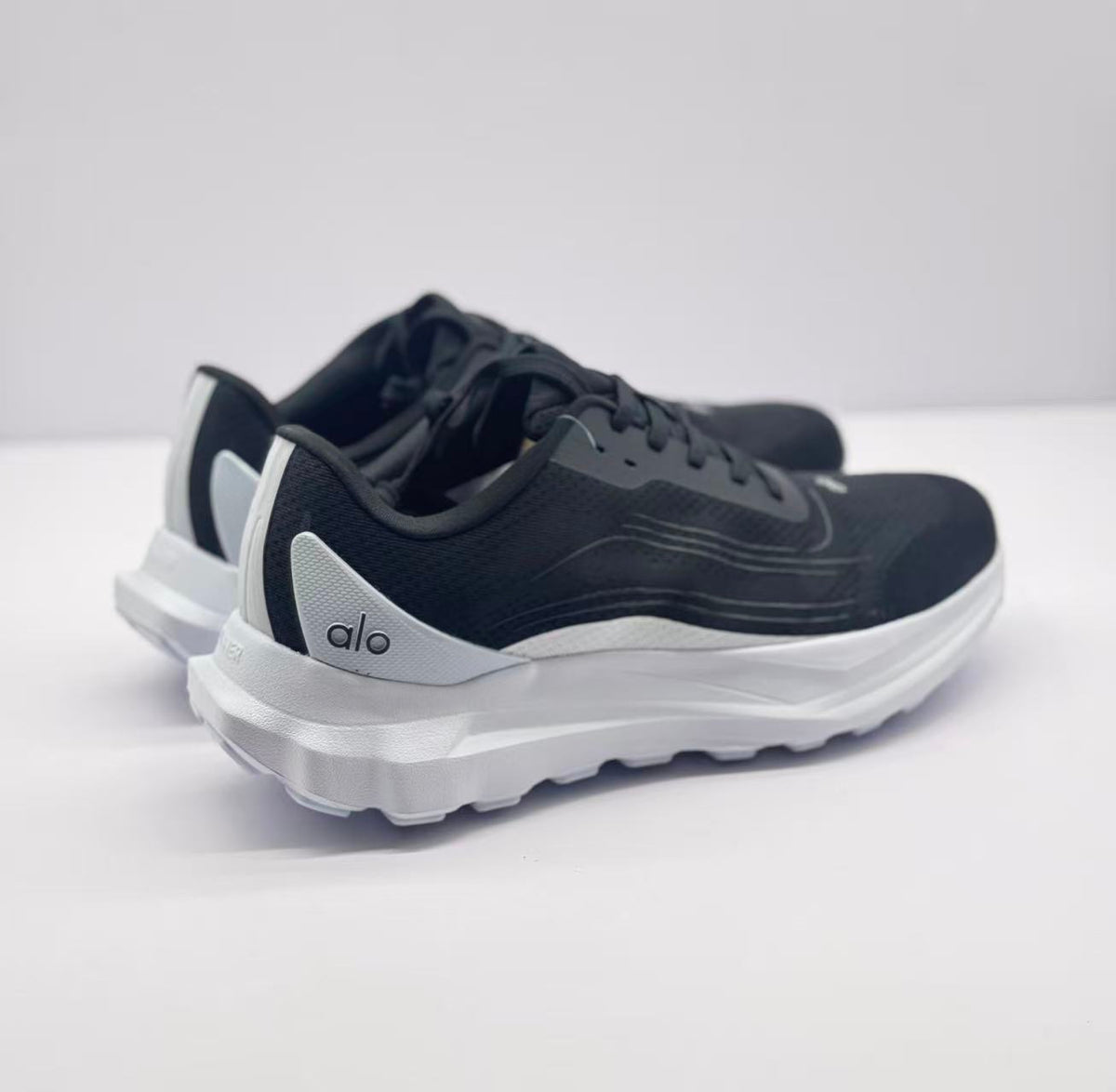Rear three-quarter view showing the white heel panels and raised soles.