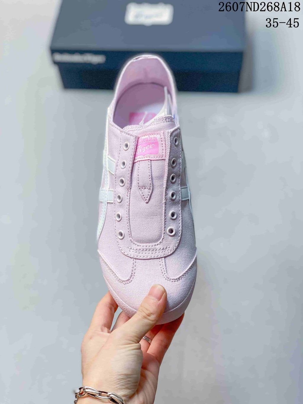 Top view of the pink sneaker showing the padded tongue, metal eyelets and branded tongue label.