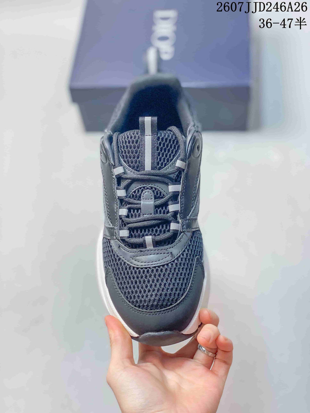 Top view of the sneaker showing the rounded toe, mesh-style tongue and toe area, laces, and layered overlays.