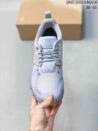 Top view of the sneaker showing the tongue, laces, textured toe box and light gray panels.