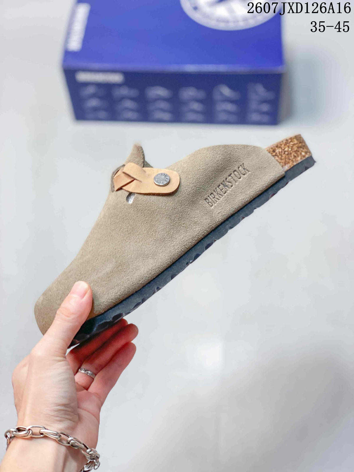 Side view of a taupe closed-toe mule with an adjustable buckle strap and visible BIRKENSTOCK marking.
