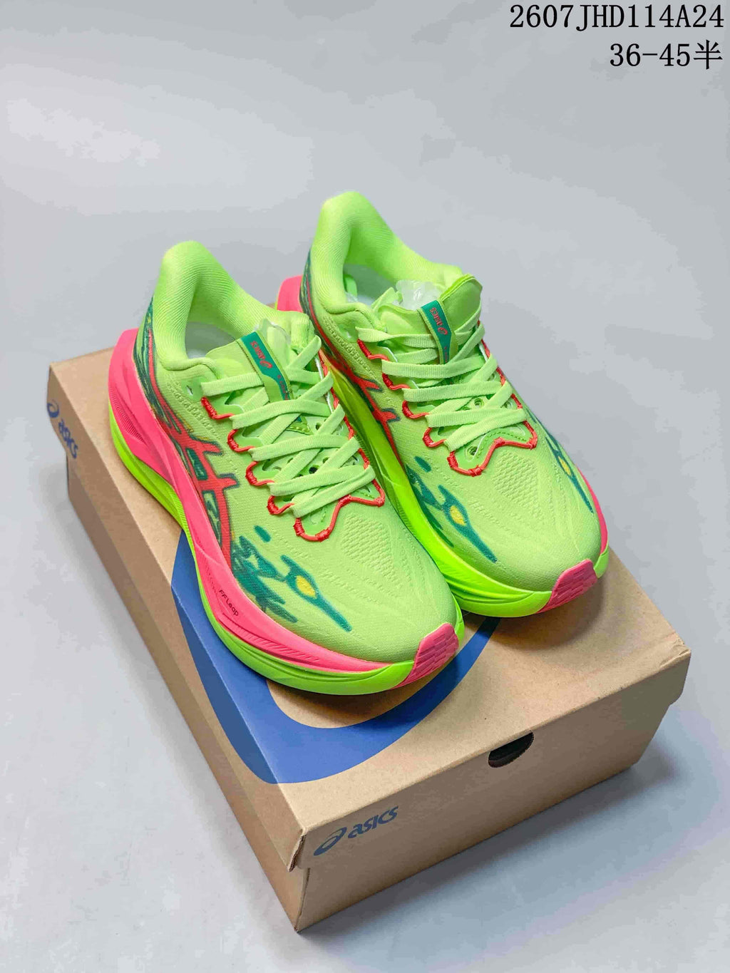 Pair of lime green and pink ASICS SUPERBLAST 3 sneakers displayed on an ASICS shoe box.