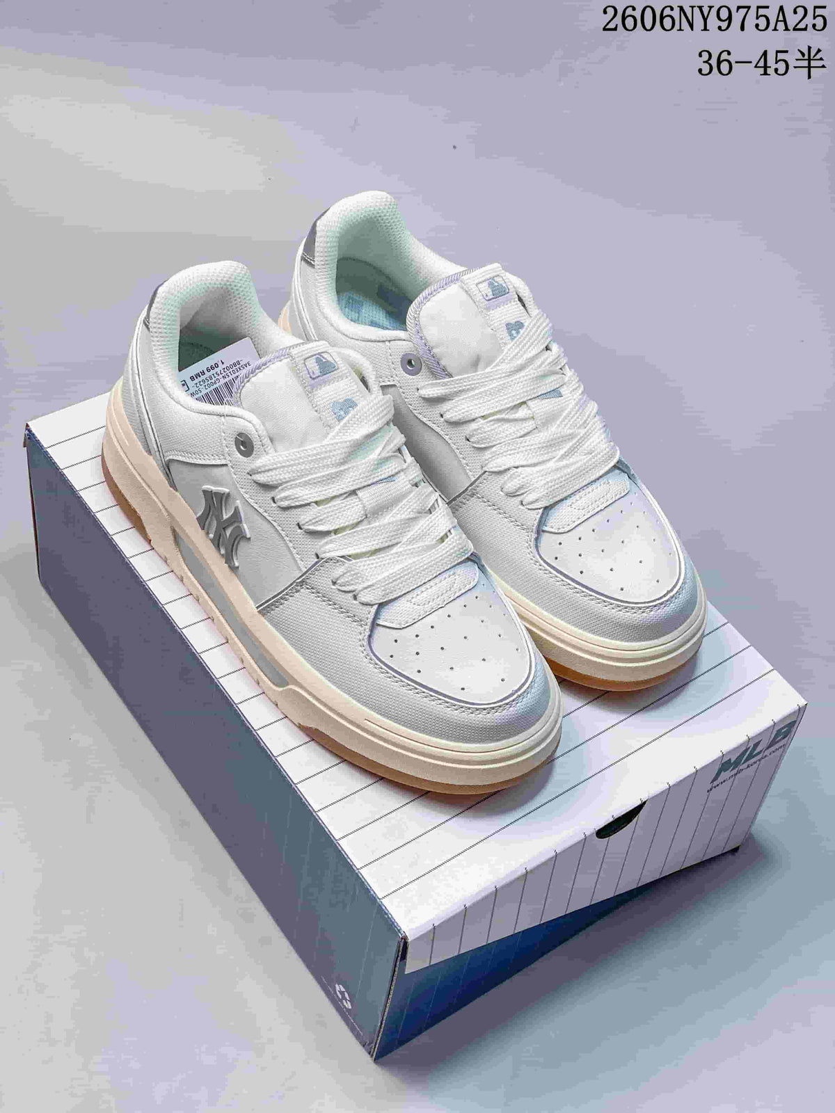 Pair of white and light-gray MLB Chunky Liner sneakers displayed on a shoebox, showing the raised sole and side lettering.
