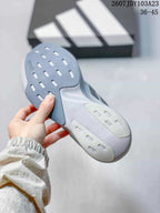 Close-up of the outsole showing gray and white sections with elongated traction openings.