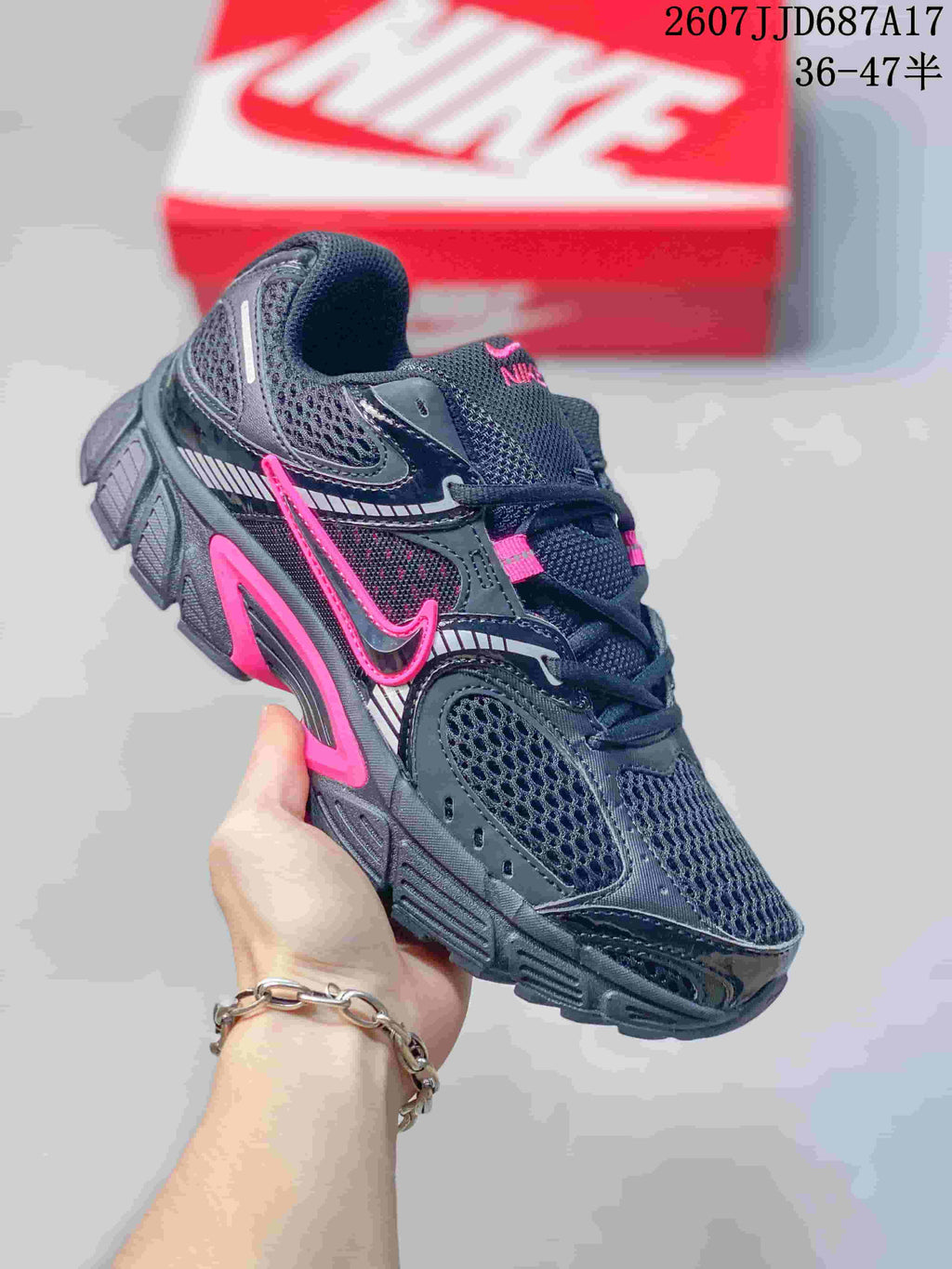 Black Nike V5 RNR sneaker with bright pink accents, open mesh panels and a sculpted sole.