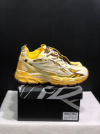 Side profile of the yellow and cream sneakers showing layered panels, mesh sections, and a segmented outsole.