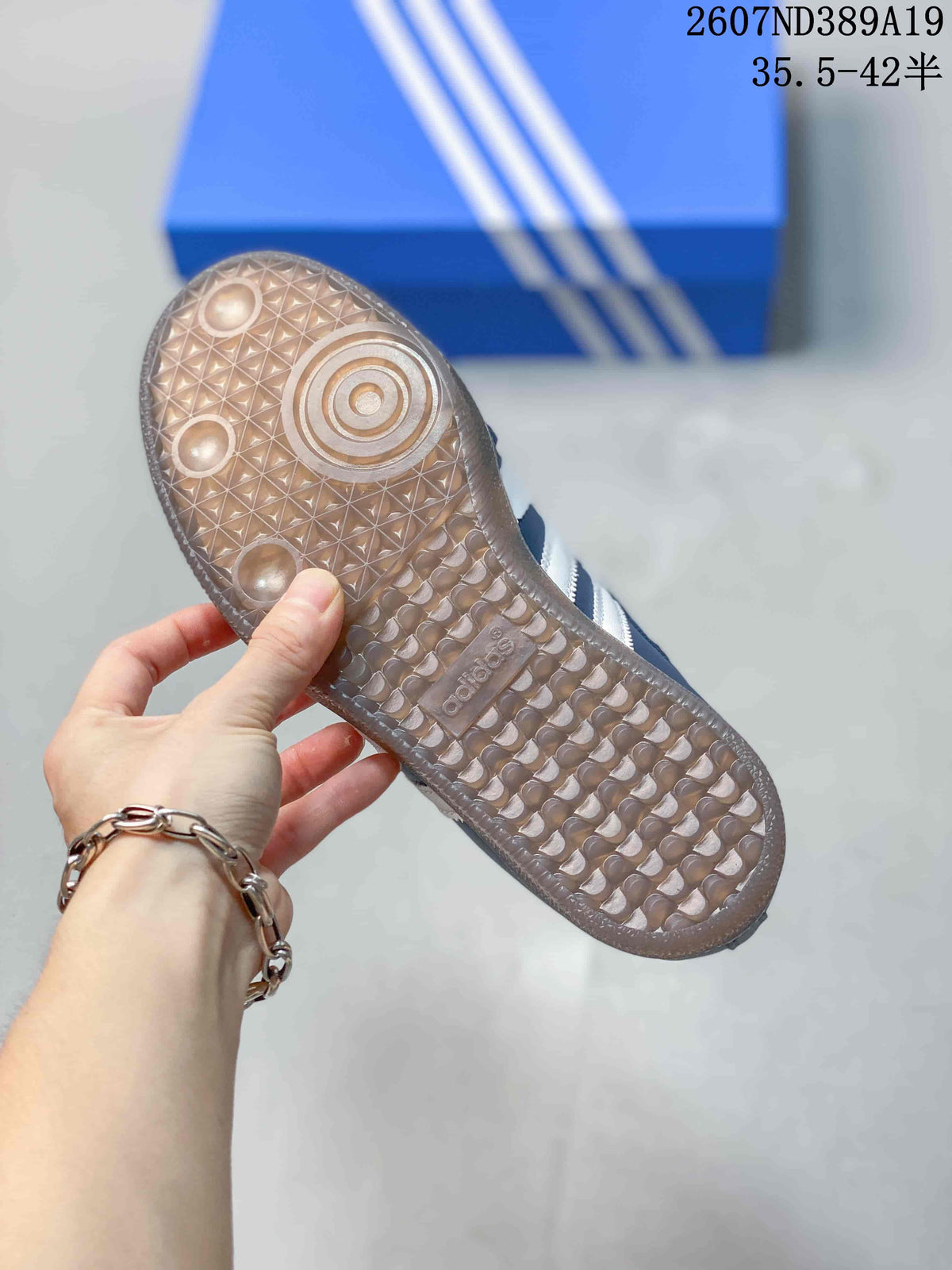 Close view of the translucent gum-style outsole with circular traction details and a textured tread pattern.