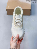 Top view of the white lace-up running shoe