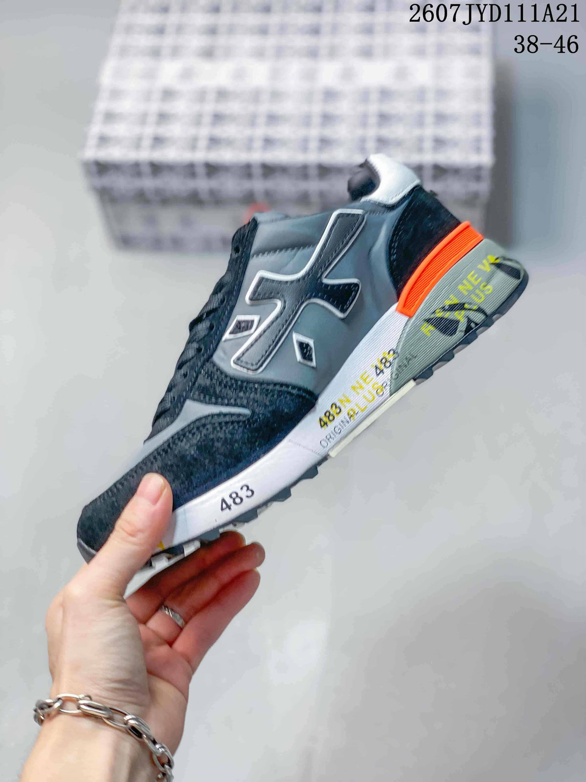 Side profile of the sneaker showing contrasting panels, large side detailing and a layered sole.