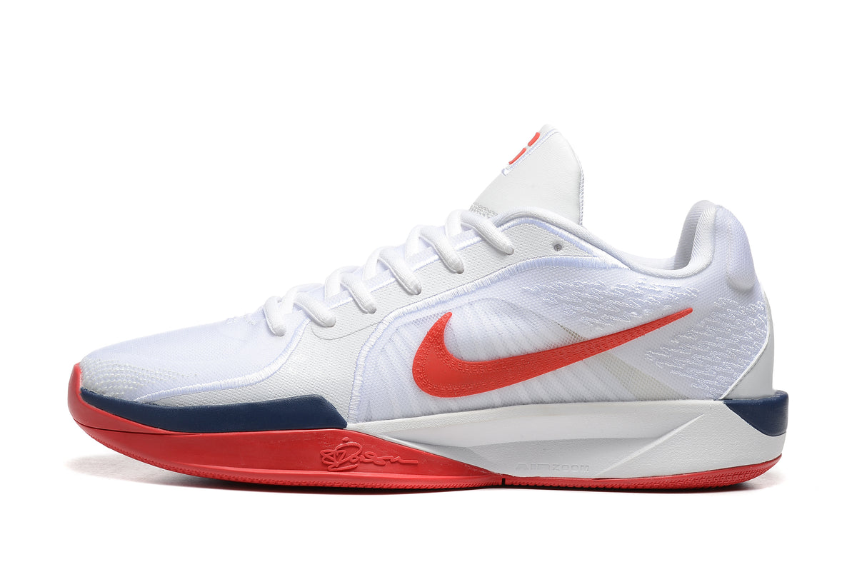 Side profile of a white Nike Sabrina 1 shoe with red Swoosh and navy accents