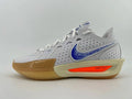 Side view of a light gray and white Nike running shoe with a blue patterned Swoosh, orange midsole accent, and gum-colored outsole.