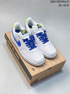 Pair of white Nike Court Vision Low sneakers with blue laces and yellow accents displayed on a shoebox.