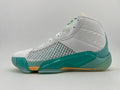 Side view of white and light gray high-top basketball shoes with teal and orange accents and a woven side panel