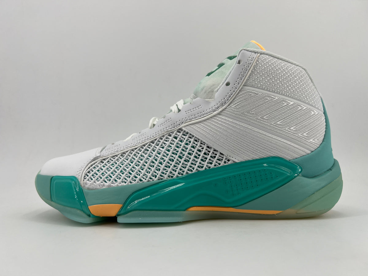 Side view of white and light gray high-top basketball shoes with teal and orange accents and a woven side panel
