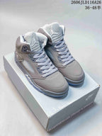Pair of grey Jordan Air Jordan 5 Retro high-top sneakers on a shoe box