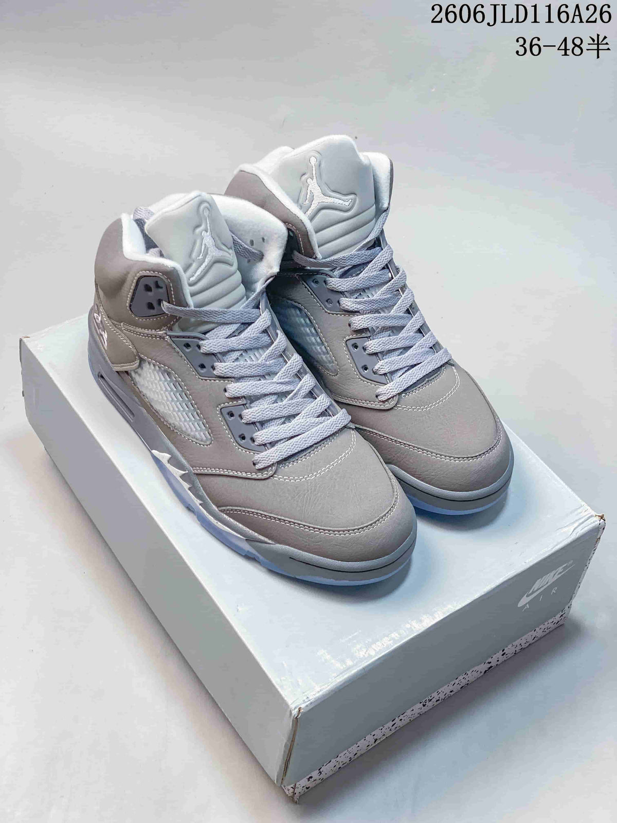 Pair of grey Jordan Air Jordan 5 Retro high-top sneakers on a shoe box