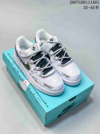 White Nike Court Vision low-top sneakers with colorful graphics and gray-and-dark laces on a turquoise box