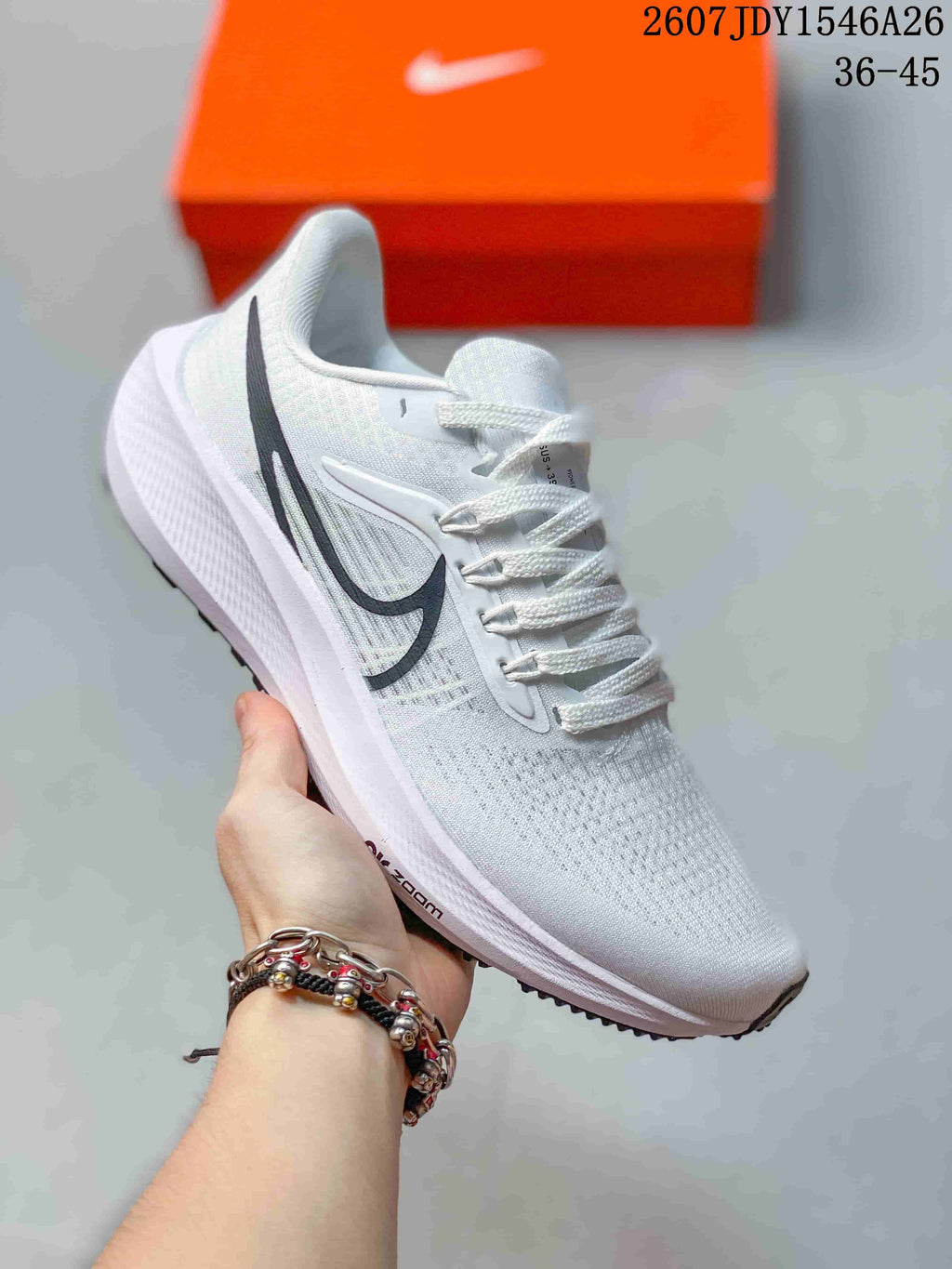 White Nike Air Zoom Pegasus 39 sneaker with black side branding and white laces.