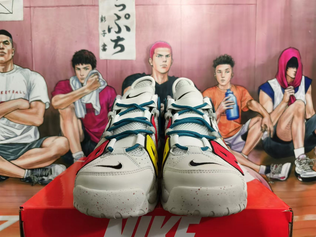 Front view of white Nike basketball shoes with teal laces, black swooshes, and colorful accents.