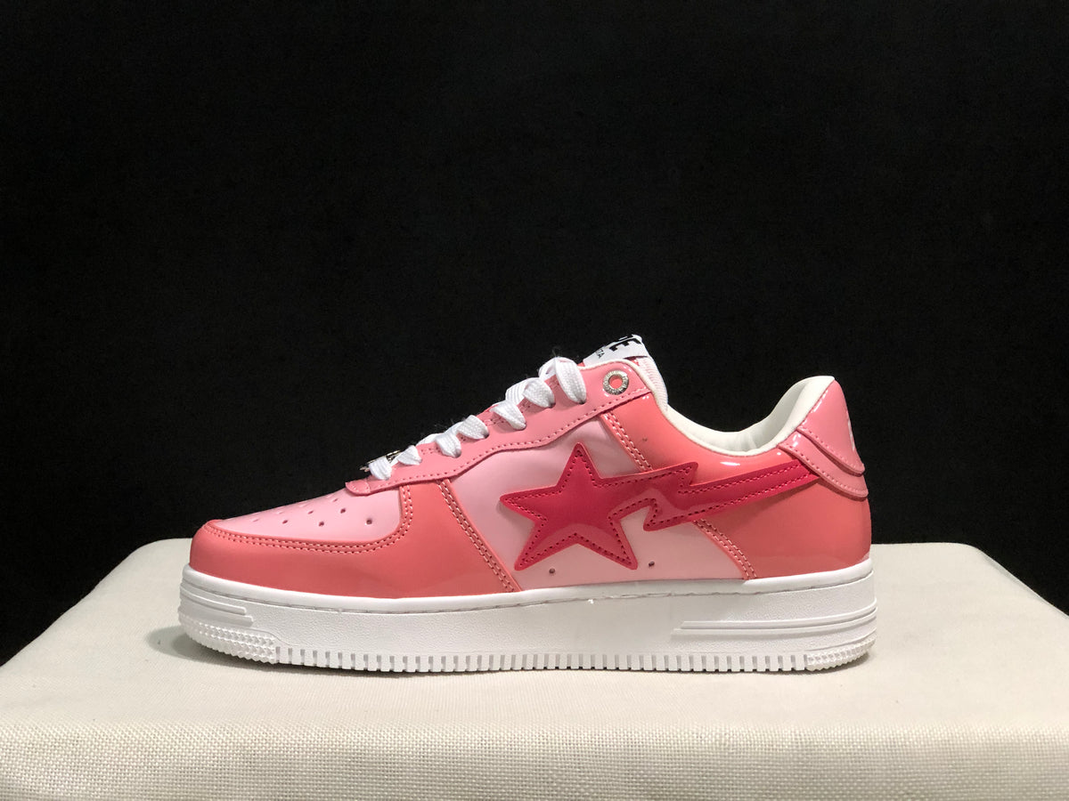 Clean side profile showing the pink and white low-top silhouette and star-shaped side graphic.