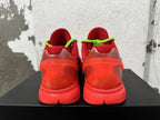 Rear view of red Nike Kobe basketball sneakers with neon green laces and signature-style heel details
