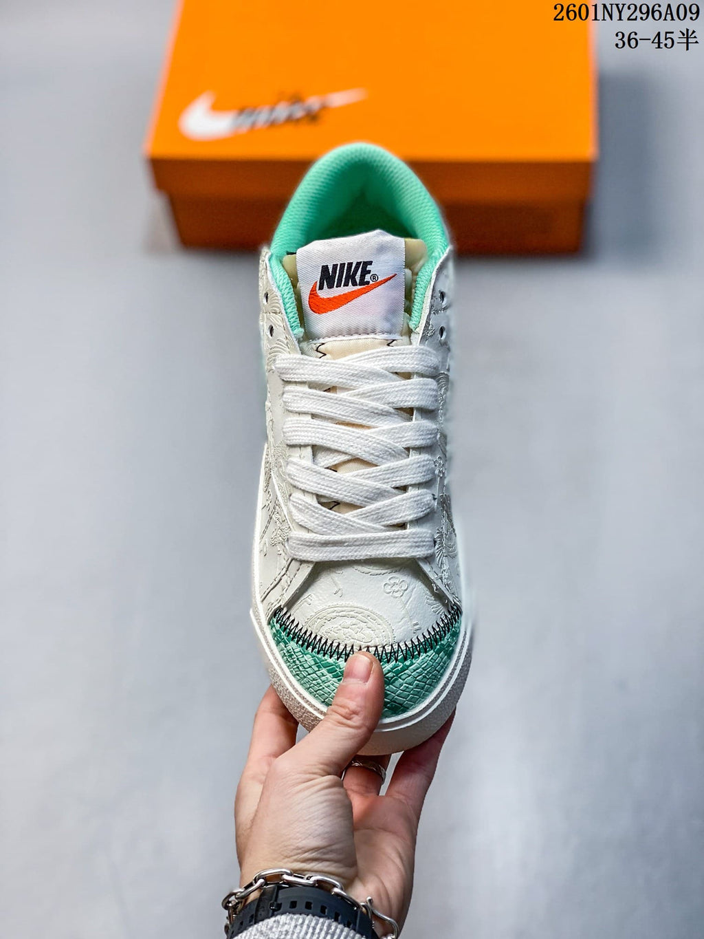 Front view showing the white laces, padded tongue, and green patterned toe panel.