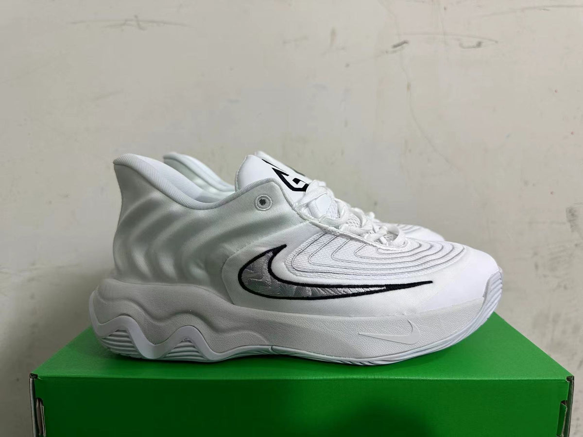 Side view of a white and grey Nike sneaker with a black-outlined side logo