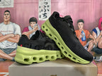 Pair of black sneakers with lime-green soles, shown at an angle