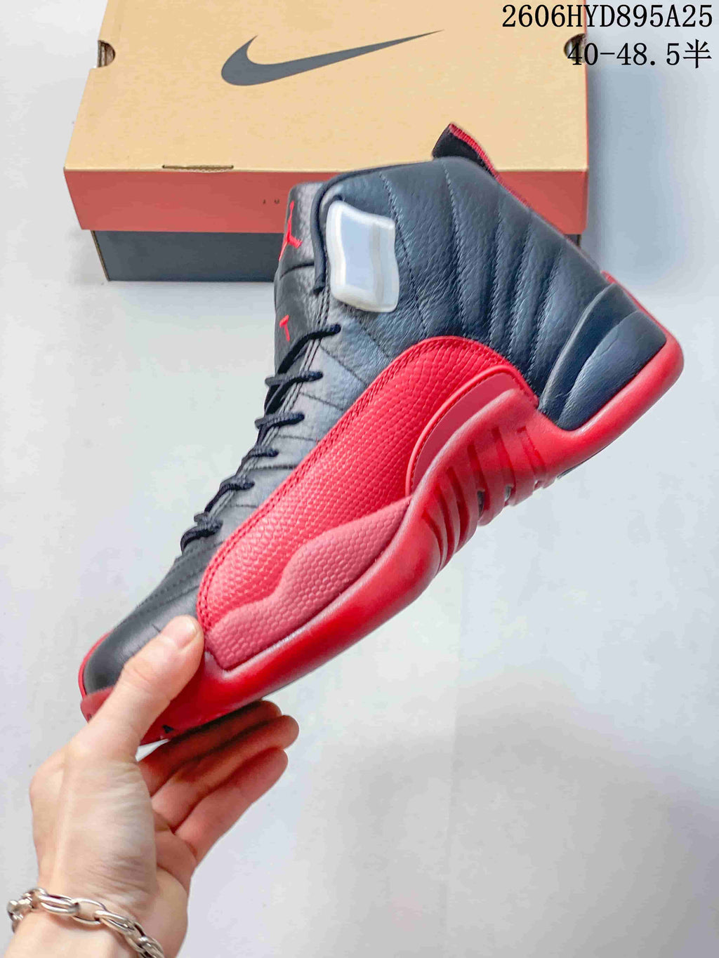 Side profile of a black and red Jordan Air Jordan 12 high-top sneaker