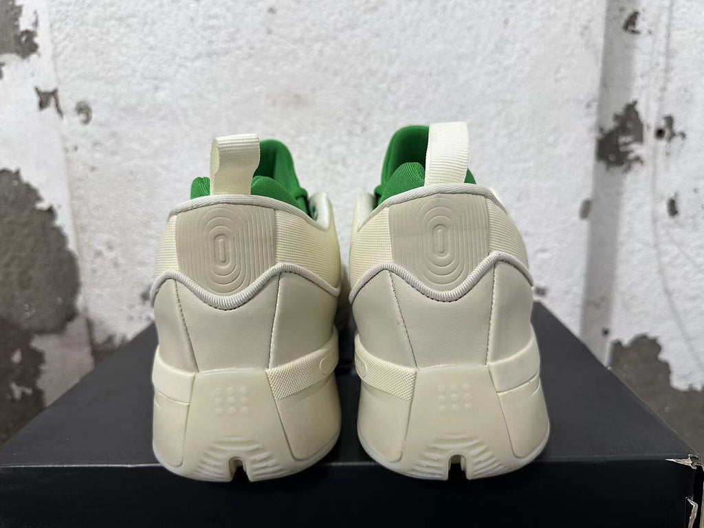 Rear view of cream and green Dame 9 basketball shoes