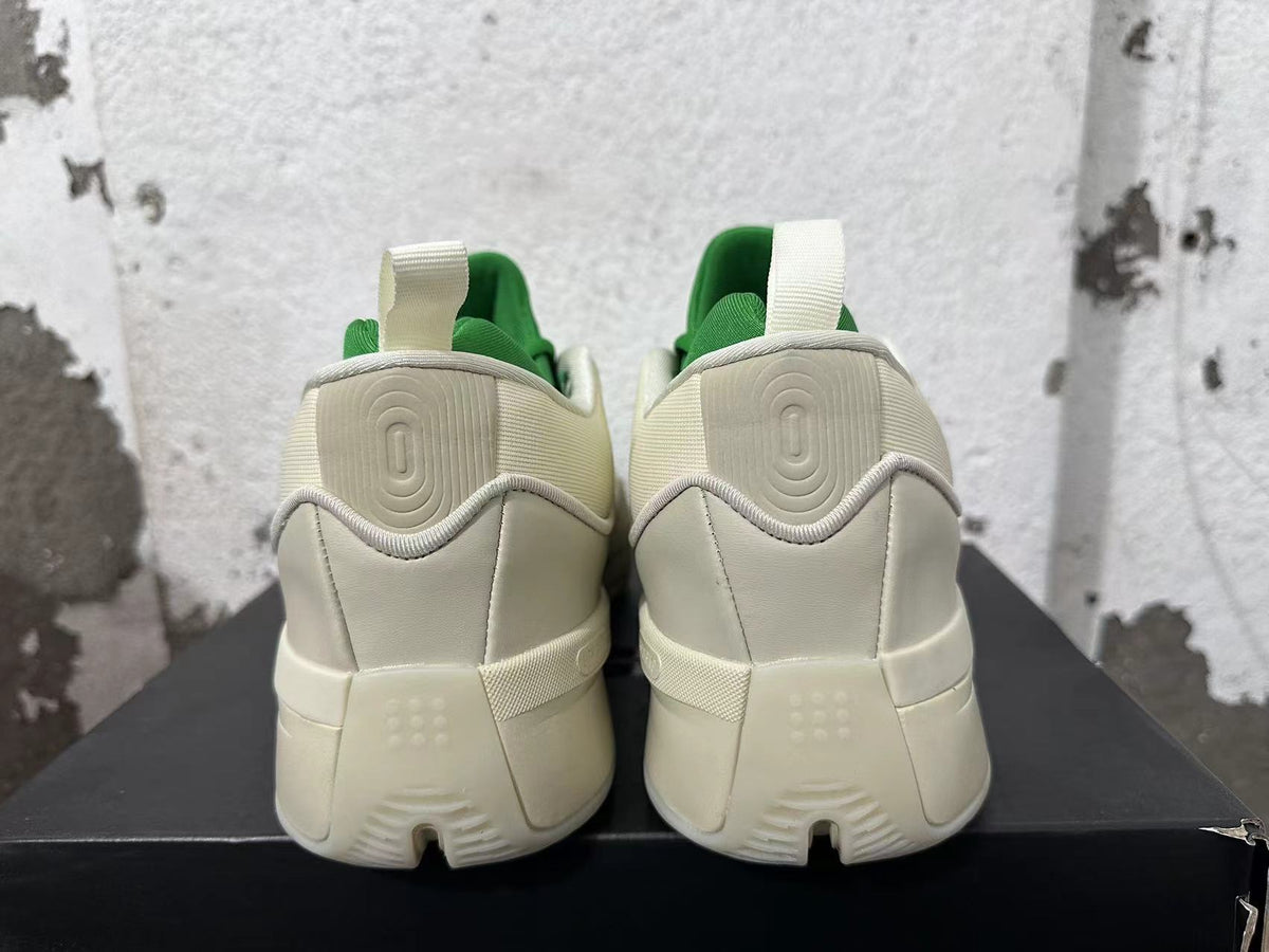 Rear view of cream and green Dame 9 basketball shoes