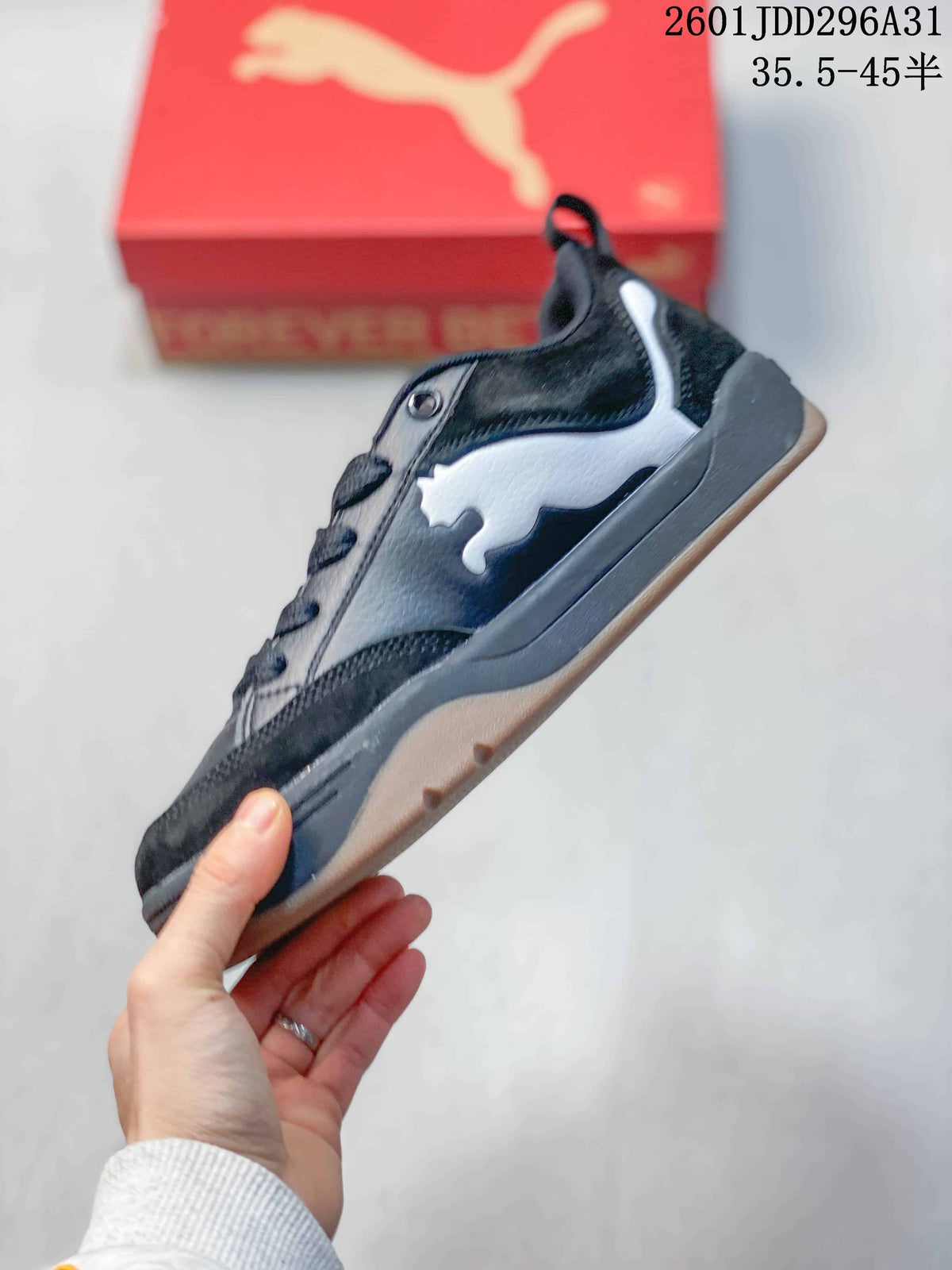 Side profile of a black and white PUMA sneaker showing the layered upper, side logo and gum-colored outsole.
