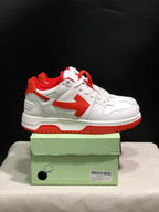 Side view of the white and red low-top sneakers showing the contrasting arrow detail and red outsole.