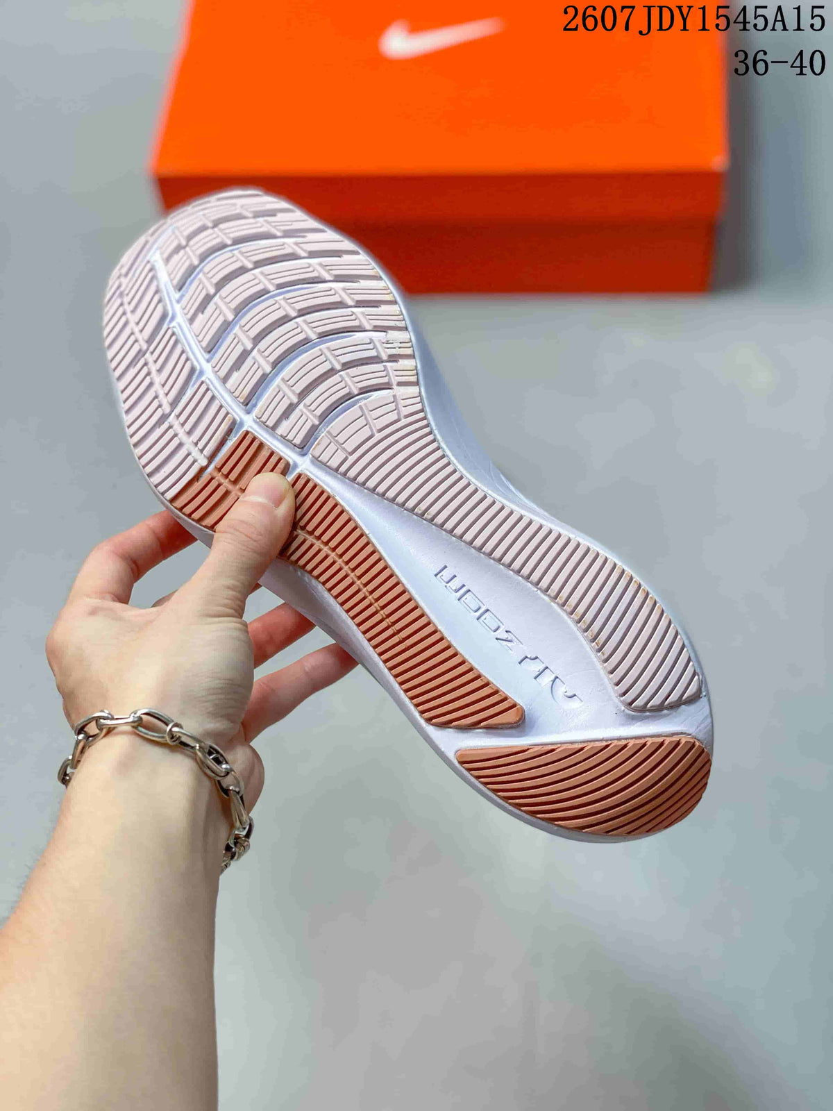 Close view of the sneaker outsole showing a segmented tread pattern with contrasting pink sections.