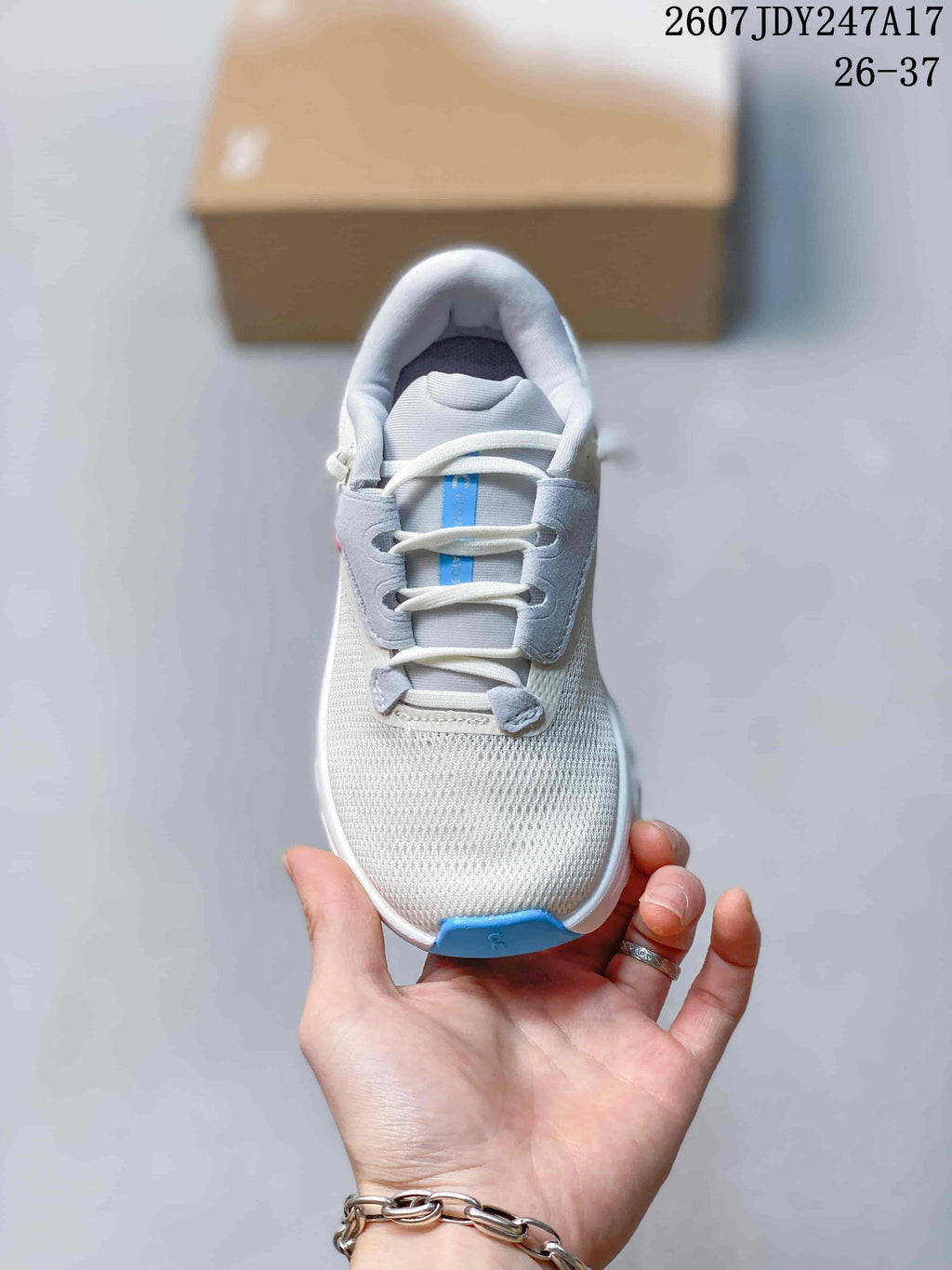 Top-down view showing the rounded toe, laces, textured upper, and blue toe accent.