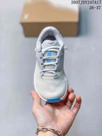 Top-down view showing the rounded toe, laces, textured upper, and blue toe accent.