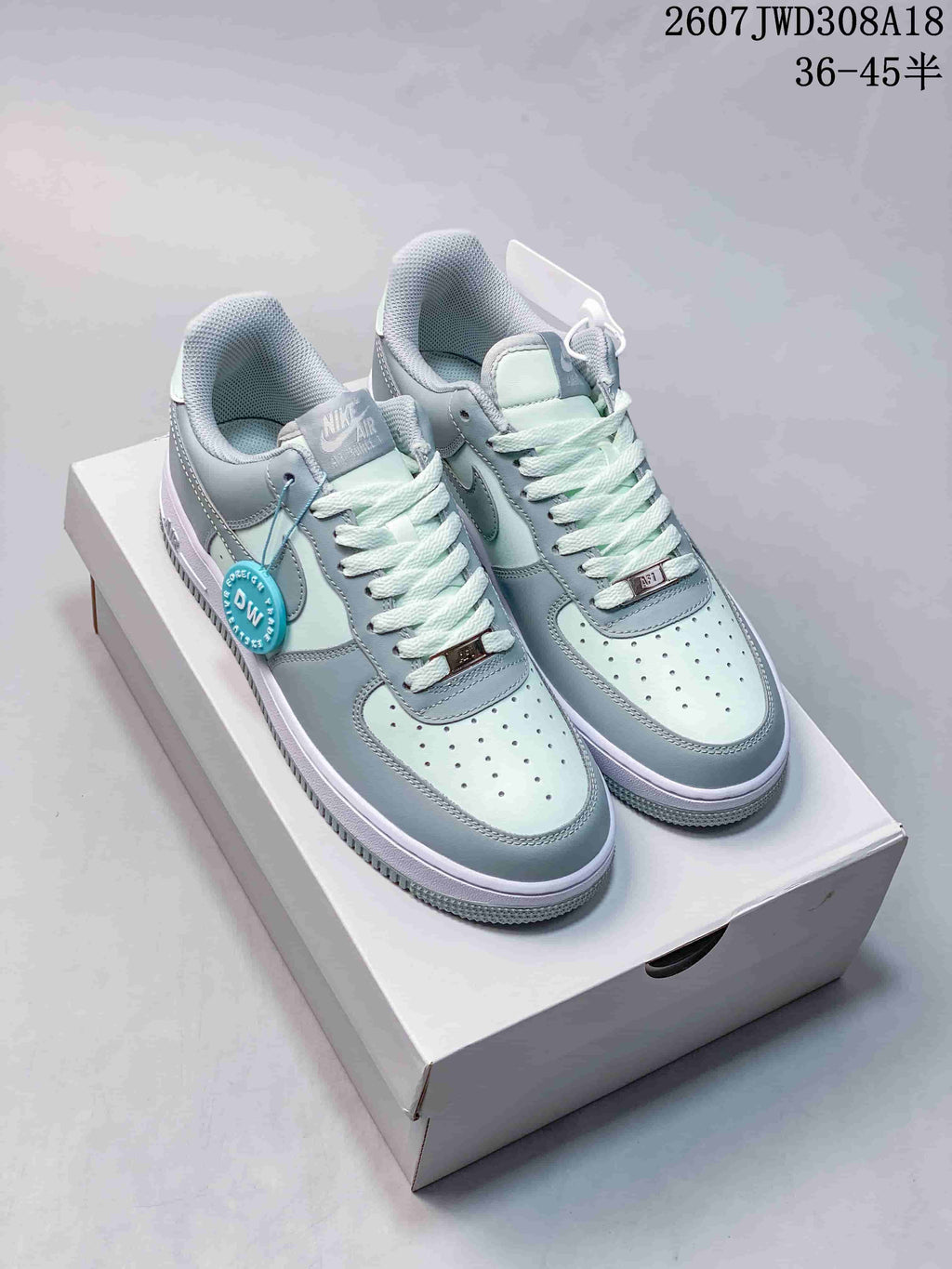 Pair of pale blue and white Nike Air Force 1 '07 style low-top sneakers displayed on a shoebox.