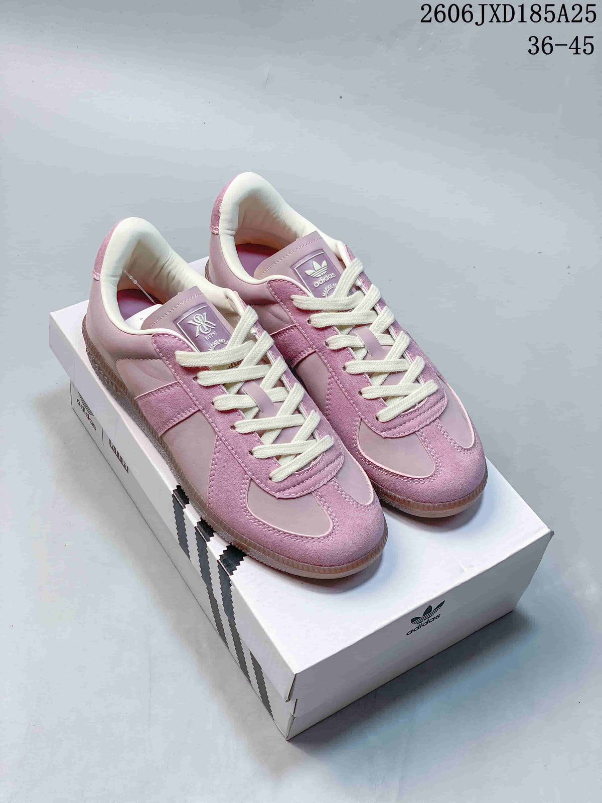 Pair of pink adidas BW Army low-top sneakers with cream laces on a shoebox.