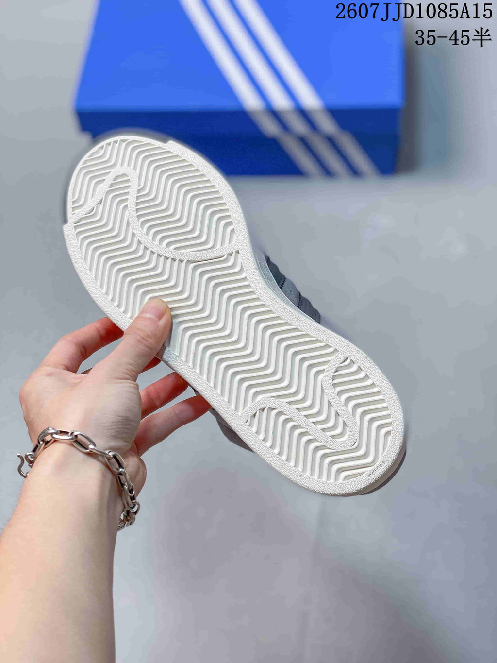 Underside of a sneaker showing a white zigzag-patterned outsole with a circular forefoot detail.