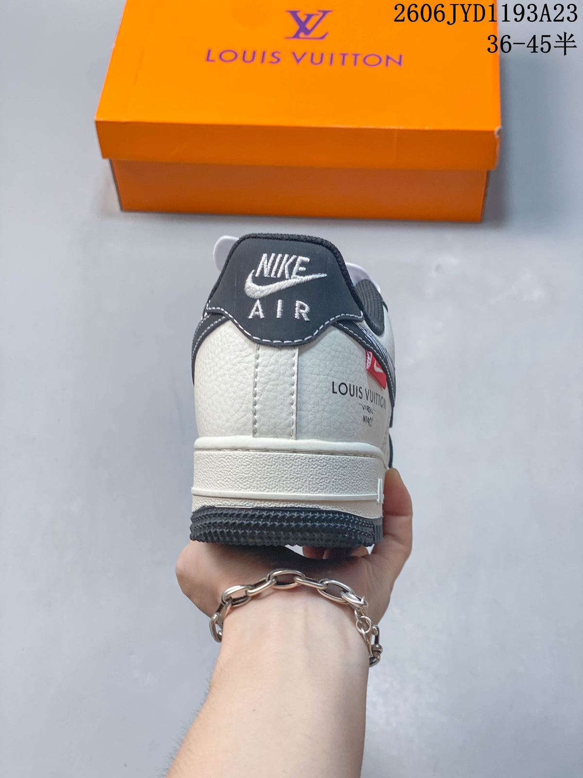 Rear view of a low-top sneaker with cream heel panel and dark heel tab