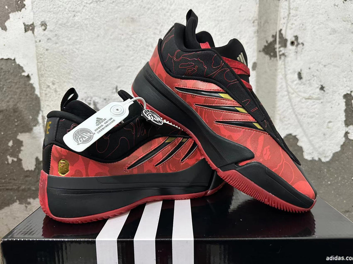 Angled view of red and black basketball shoes showing patterned panels and red outsole