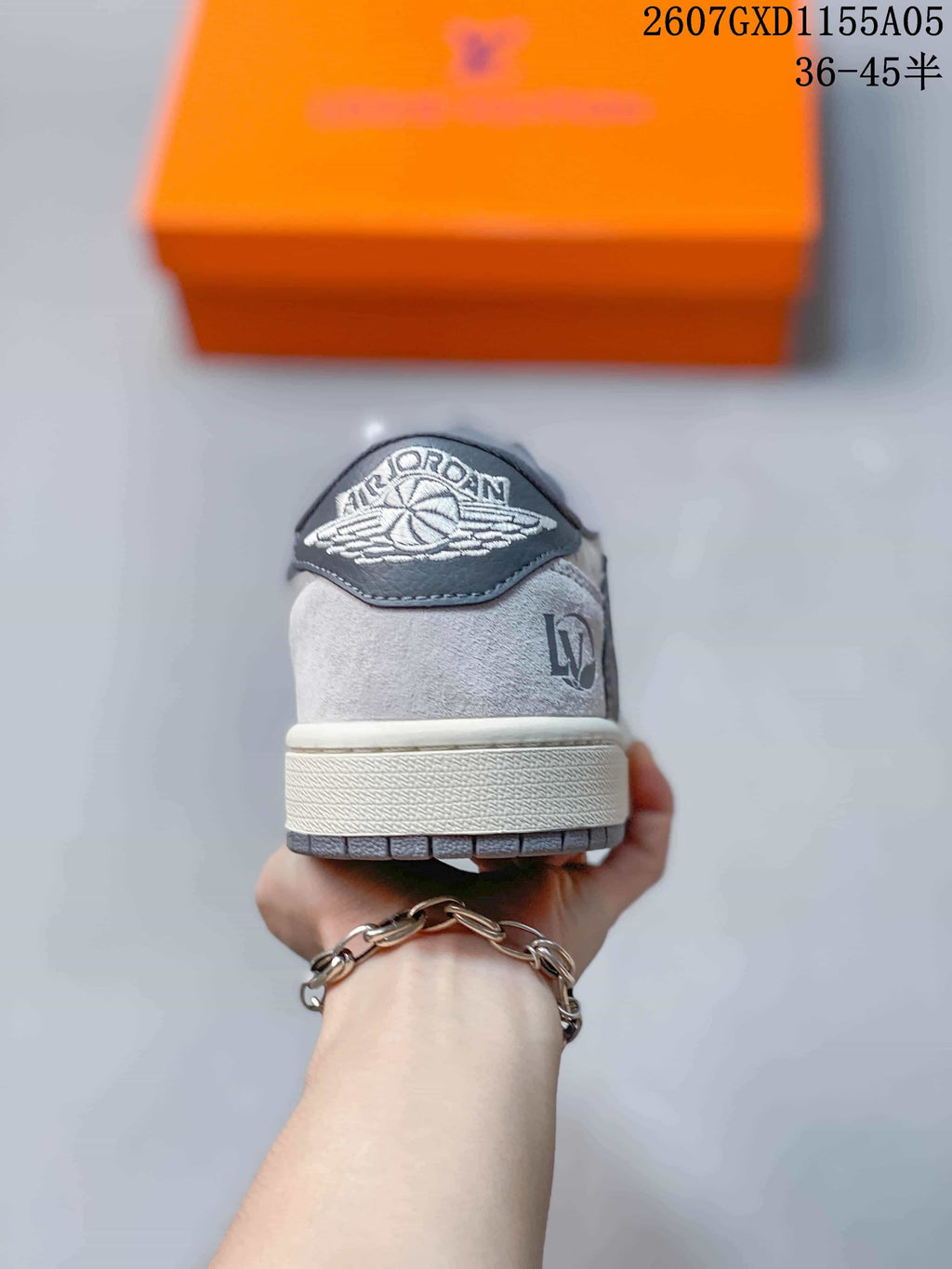 Rear view of the sneaker showing the Jordan Wings heel patch and monogram-style upper details.