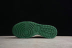 Bottom view showing the green rubber outsole with circular forefoot and grid-pattern traction details.