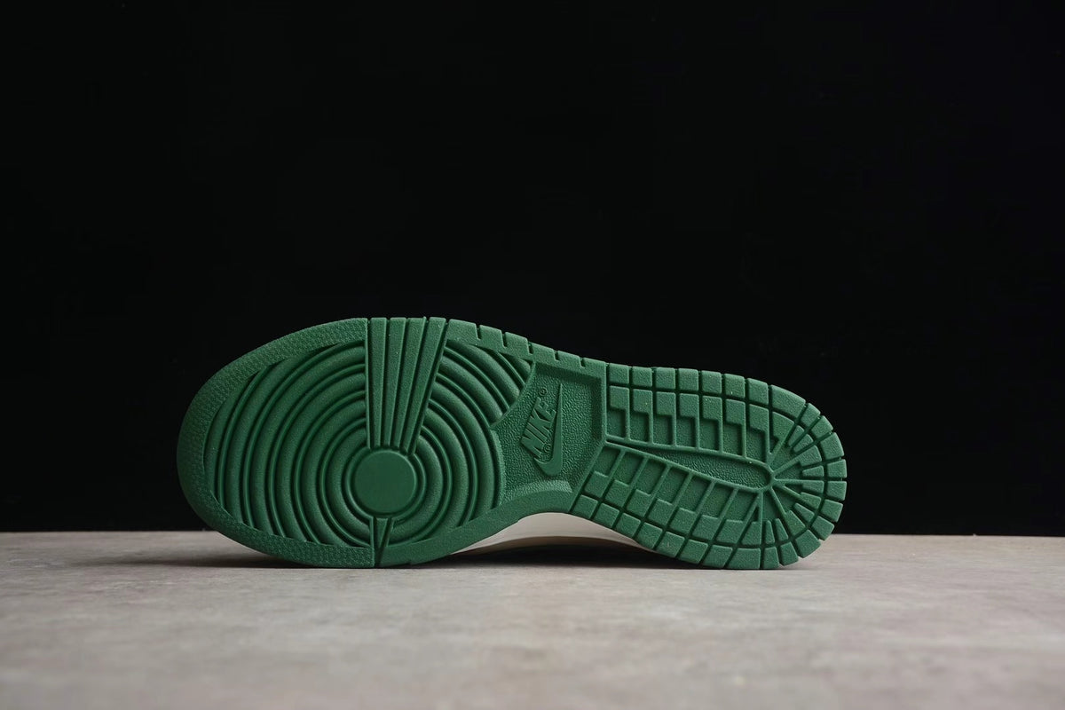 Bottom view showing the green rubber outsole with circular forefoot and grid-pattern traction details.