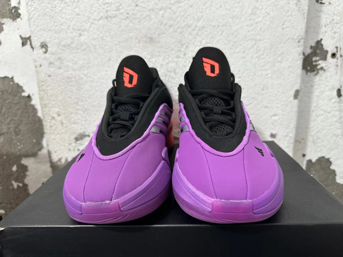 Front view showing black laces and coral tongue logos on purple adidas Dame 9 shoes